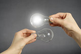 Decision making concept, hands with light bulbs.