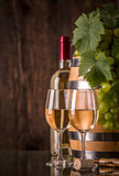 Glasses of wine with bottle barrel and grapes