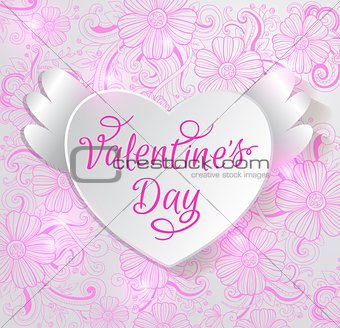 Paper heart on a pink floral background