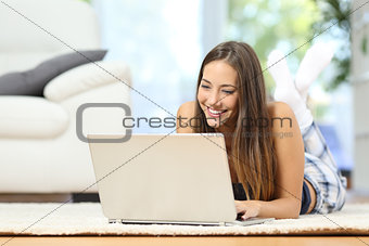 Girl online browsing a laptop at home
