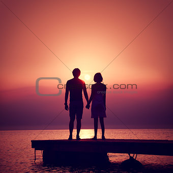 Romantic Couple Enjoying Sunset at Sea.
