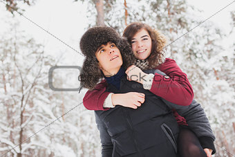Happy Young Couple in Winter Park having fun.Family Outdoors. love