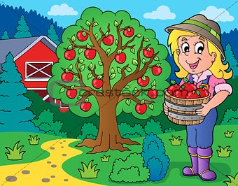 Farm girl with collected apples