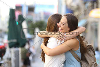 Happy meeting of friends hugging
