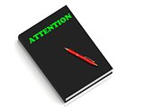 ATTENTION- inscription of green letters on black book 