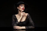 Beautiful girl with red llips in black hat
