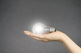 Hand with light bulb and copyspace