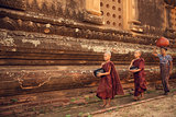Buddhist novice monks walking alms in Bagan