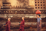 Buddhist novice monks collect alms