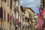 Old houses and flags in the center of Arezzo