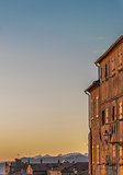 Sunset light over old buildings in Volterra