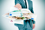 man giving an envelope full of euro bills