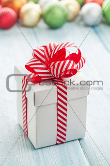Christmas gift box and colorful baubles