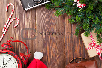 Christmas background with camera, alarm clock and tree branch