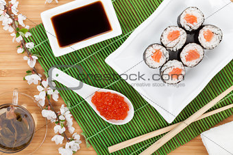 Red caviar, sushi set, sakura branch and green tea