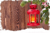 Christmas candle lantern on fir tree branch in snow
