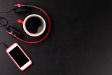 Headphones, smartphone and coffee cup