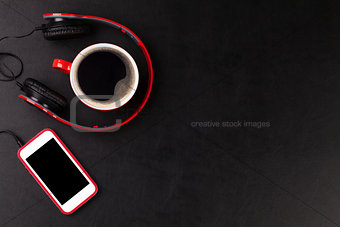 Headphones, smartphone and coffee cup