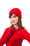 Serious winter girl in red hat, mittens  over white background