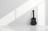 Black acoustic guitar in a white room