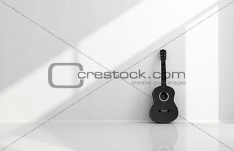 Black acoustic guitar in a white room