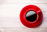 Red coffee cup on light wooden table