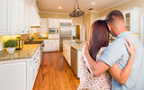 Young Hopeful Military Couple Looking At Custom Kitchen