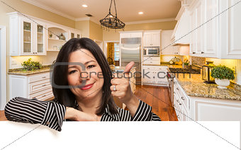 Hispanic Woman with Thumbs Up In Custom Kitchen Interior