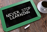 Never Stop Learning - Motivation Quote on Chalkboard.
