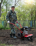 Man working in the garden preparing ground cultivator