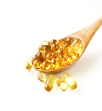 food supplement of fish oil capsules in a wooden spoon - healthy food