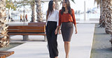 Two stylish elegant women walking together