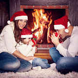 Happy family near fireplace
