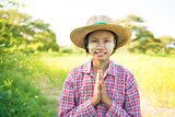 Traditional young Myanmar female farmer greeting