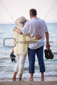 Couple embracing and looking at sea