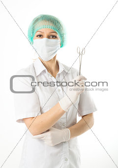 beautiful young female doctor in medical gown and rubber gloves holding a medical clamp. nurse