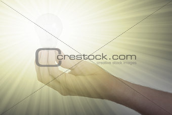 Hand holding an light bulb 