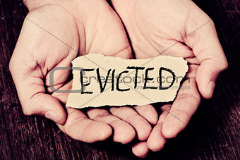 man with a piece of paper with the word evicted