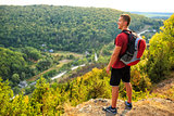 Men walk along the hill with backpack