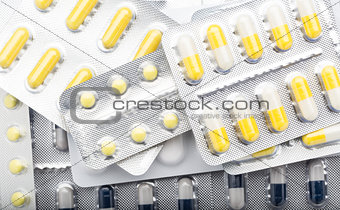 Lot pill packs of colorful tablets and capsules