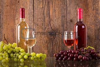 Glasses of wine with bottles and grapes