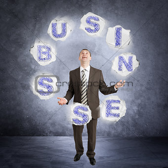 Businessman juggling word business