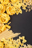 Different types of pasta on the black background
