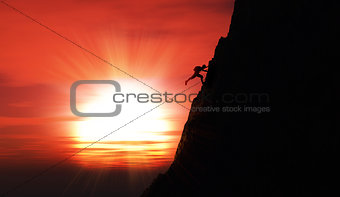 Extreme rock climber against a sunset sky