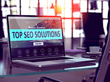 Top SEO Solutions Concept on Laptop Screen.
