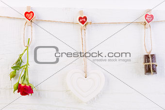 Red rose with white shape heart and chocolate on white