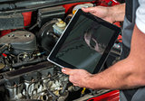 Mechanic using a tablet pc at the repair garage