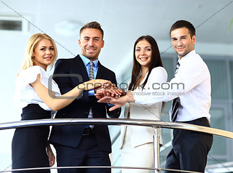business team showing unity with their hands together