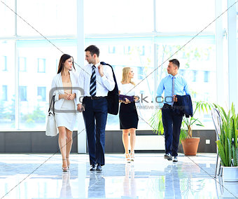 businesspeople group walking at modern bright office interior