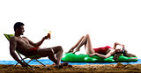couple on the beach drinking
